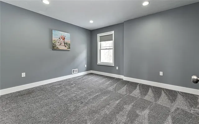 a bathroom with a granite countertop sink a toilet and shower