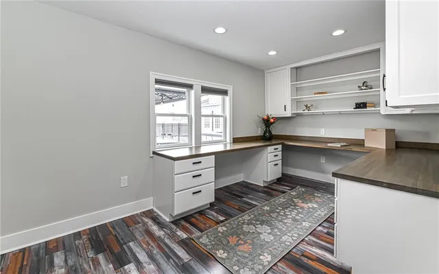 a bathroom with a granite countertop sink a toilet and shower