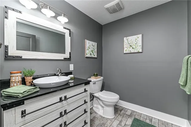 a view of a hallway with wooden floor and a living room