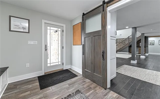 a view of an empty room with wooden floor