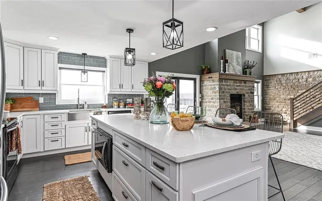 a open kitchen with stainless steel appliances granite countertop a sink and a stove