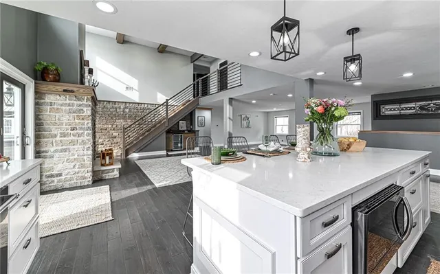 a kitchen with a sink a stove and chairs