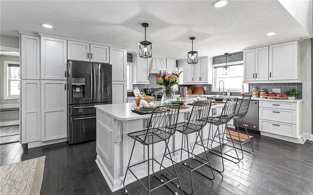 a kitchen with white cabinets and stainless steel appliances