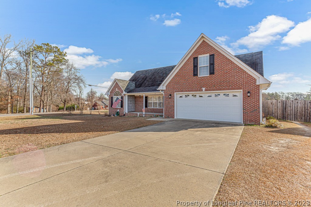 117 Ridgeview Drive Raeford, NC 28376 - Photo 2 of 31 a front view of a house with a yard and garage