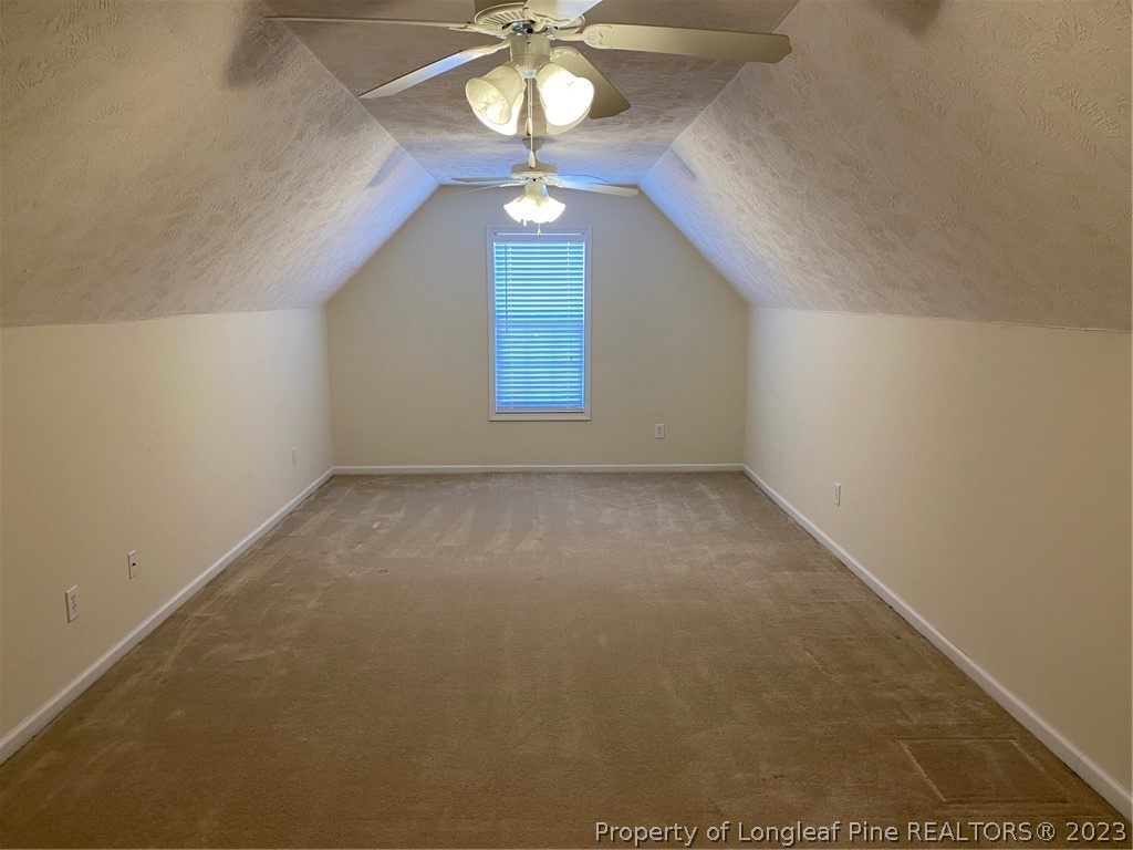 117 Ridgeview Drive Raeford, NC 28376 - Photo 25 of 31 an empty room with a chandelier fan and windows