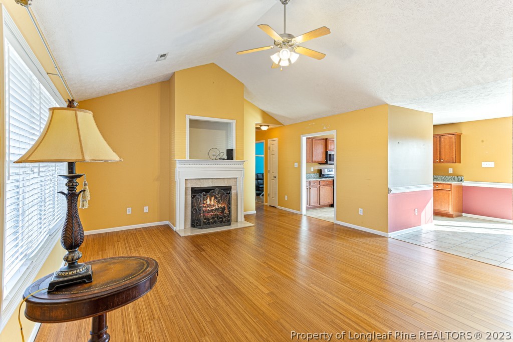 117 Ridgeview Drive Raeford, NC 28376 - Photo 7 of 31 a view of a livingroom with a fireplace and wooden floor