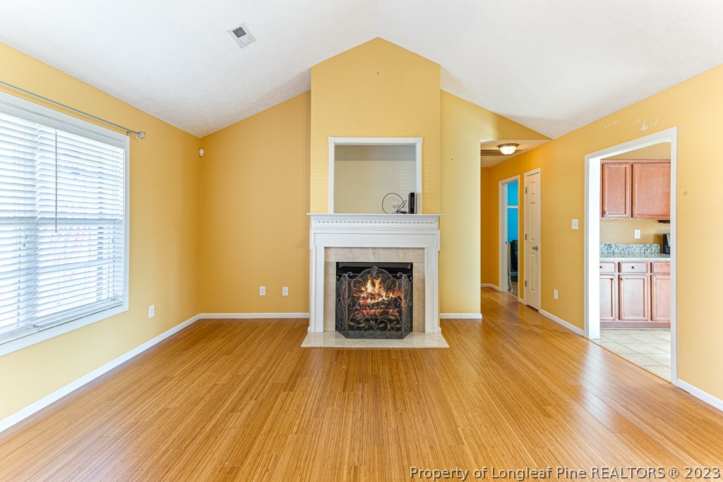 117 Ridgeview Drive Raeford, NC 28376 - Photo 8 of 31 a view of an empty room with a fireplace and a window