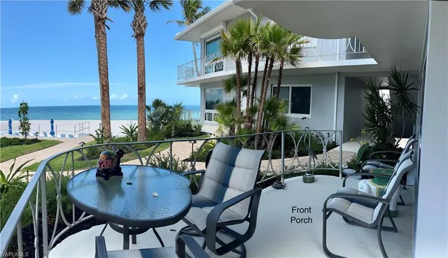 a view of a house with backyard and sitting area