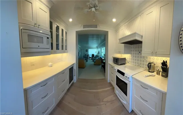 a kitchen with stainless steel appliances granite countertop a sink and stove top oven