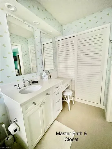 a spacious bathroom with a double vanity sink and a mirror