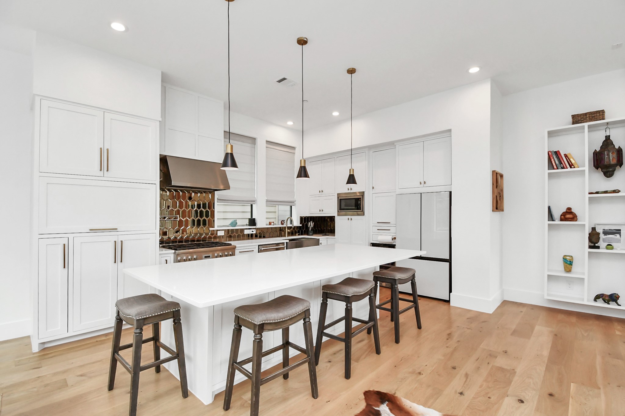 2303 Yupon Street Houston, TX 77006 - Photo 20 of 48 a kitchen with stainless steel appliances a refrigerator a stove a sink dishwasher and white cabinets with wooden floor