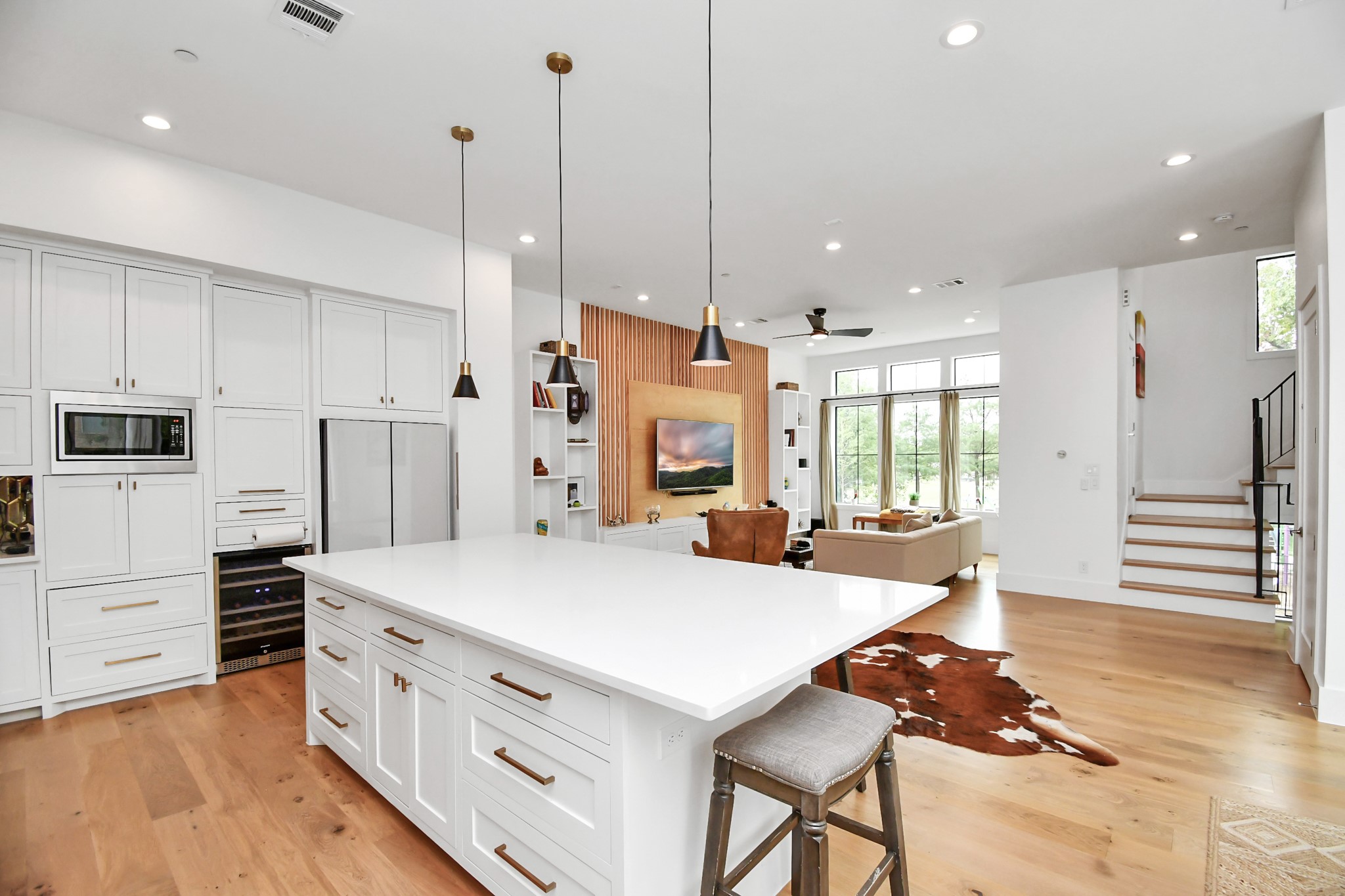 2303 Yupon Street Houston, TX 77006 - Photo 21 of 48 a kitchen with stainless steel appliances kitchen island granite countertop a refrigerator a stove and white cabinets with wooden floors