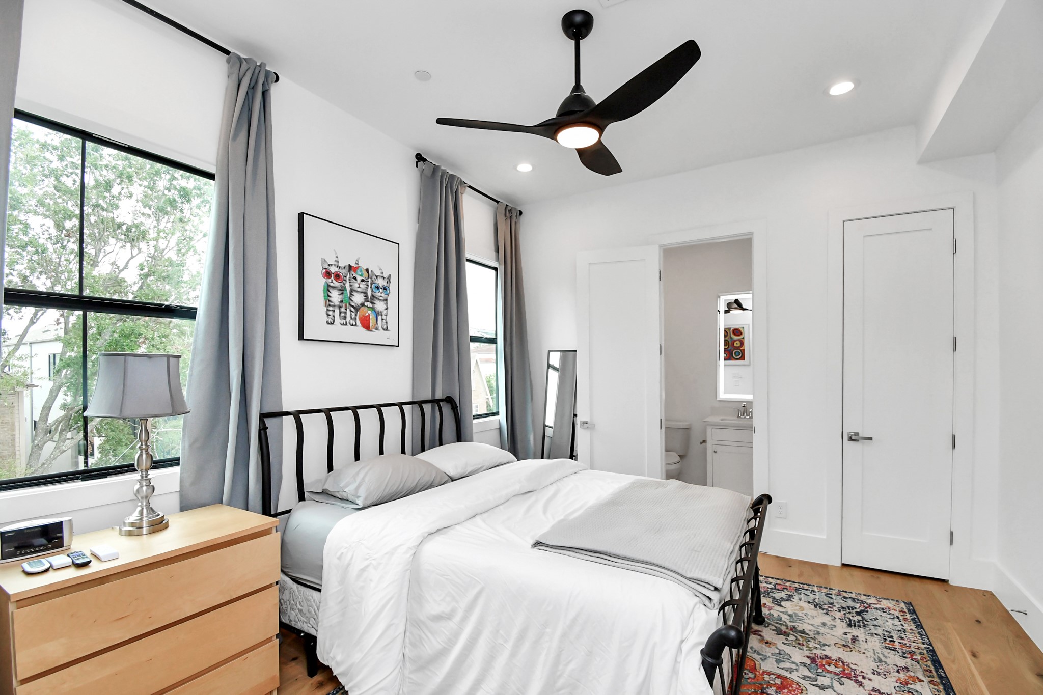 2303 Yupon Street Houston, TX 77006 - Photo 39 of 48 a bedroom with a bed a large window with the outer view