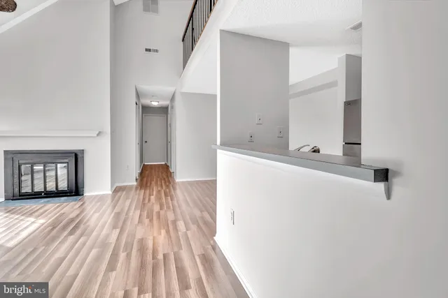a view of a room with wooden floor and stairs