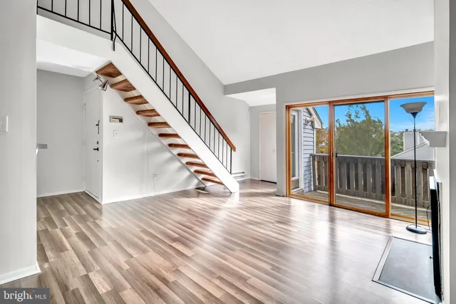 a view of an entryway with wooden floor