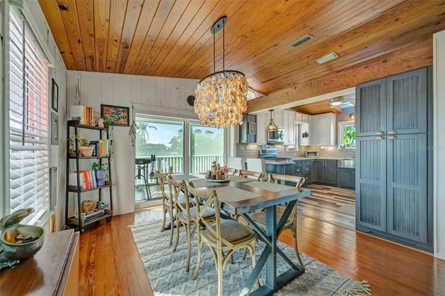 a living room with furniture a chandelier and a large window