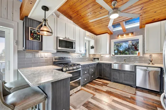a spacious bedroom with a bed and a chandelier