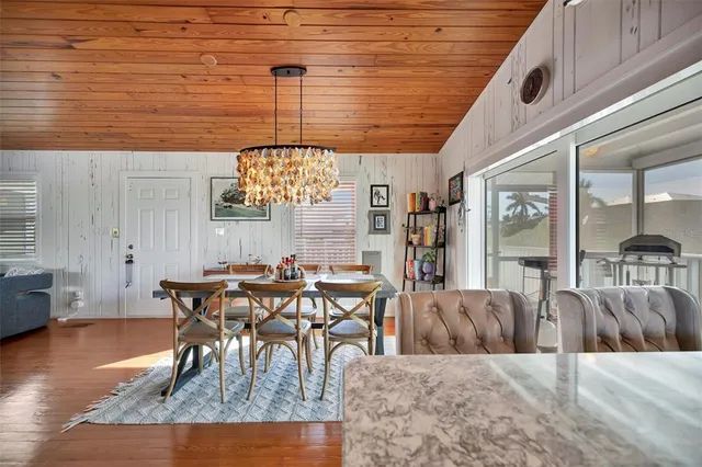 a large kitchen with kitchen island a large counter space a sink stainless steel appliances and cabinets