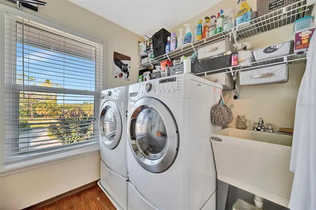 an aerial view of a house with swimming pool and sitting area