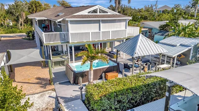 an aerial view of a house with a garden and lake view