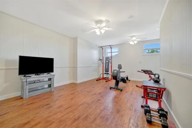 a view of a tennis ground with large trees
