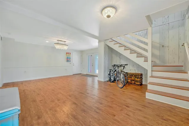 a view of a patio with lawn chairs and wooden floor
