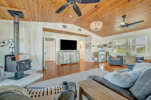a living room with furniture kitchen view and a large window