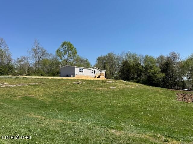 149 Powell Valley School Road Speedwell, TN 37870 - Photo 23 of 30 a green field with lots of trees in it
