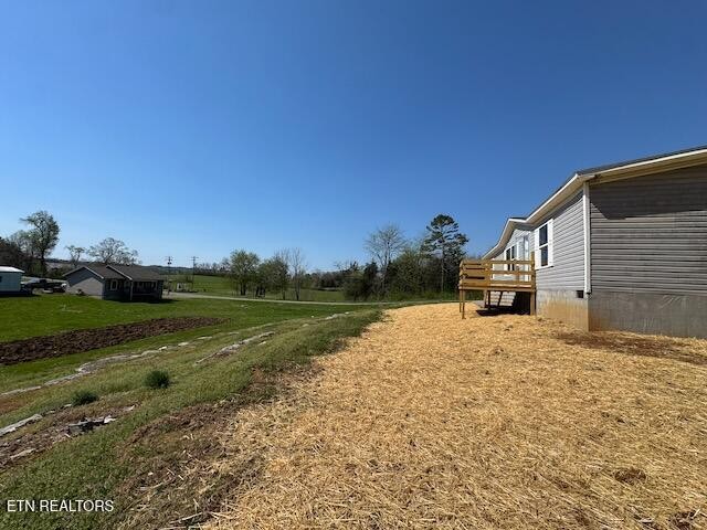 149 Powell Valley School Road Speedwell, TN 37870 - Photo 27 of 30 a backyard of a house with lots of green space and garden
