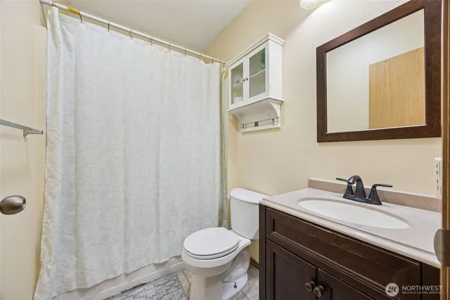 a bathroom with a sink a toilet and a mirror