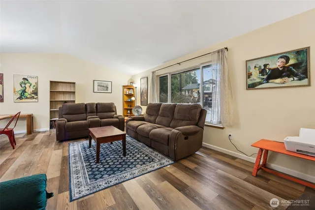 a living room with furniture a rug and a window