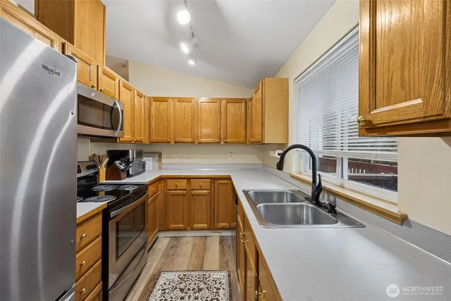 a kitchen with a sink a stove and cabinets