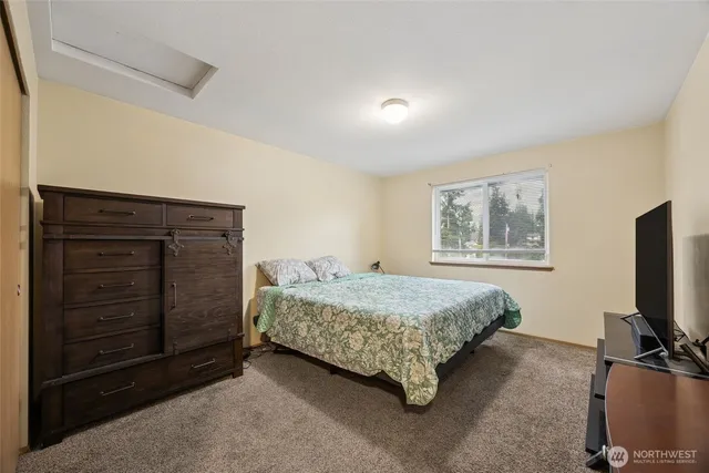 a bedroom with a bed and a television in it