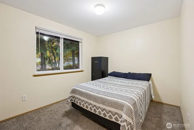 a bedroom with a bed and a window