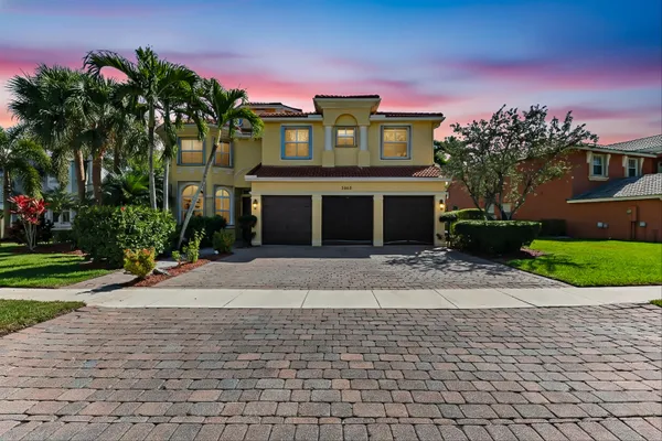 a front view of a house with a yard and a garage