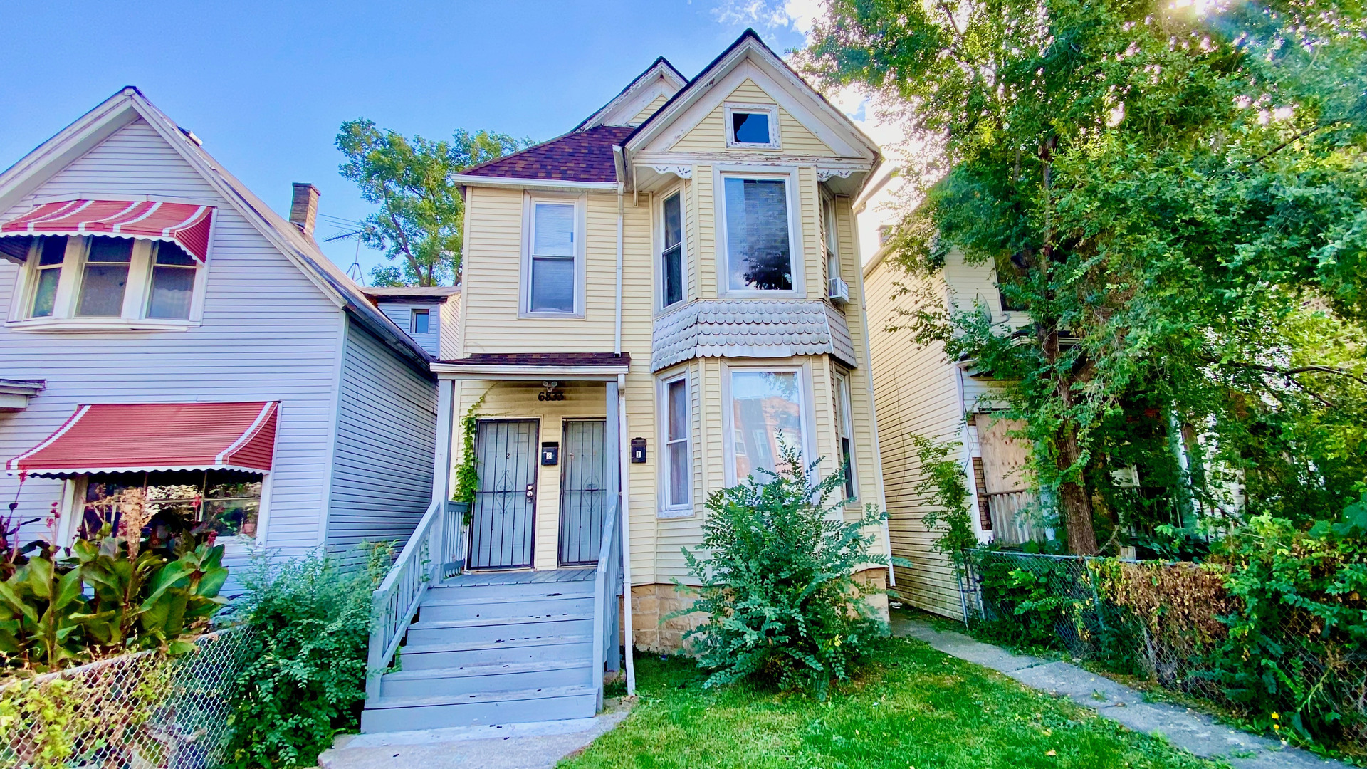 6833 South Green Street Chicago, IL 60621 - Photo 2 of 11 a front view of a house with garden