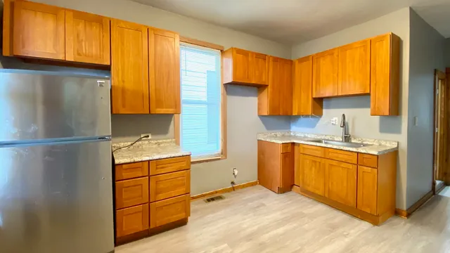 a kitchen with stainless steel appliances granite countertop a refrigerator sink and cabinets