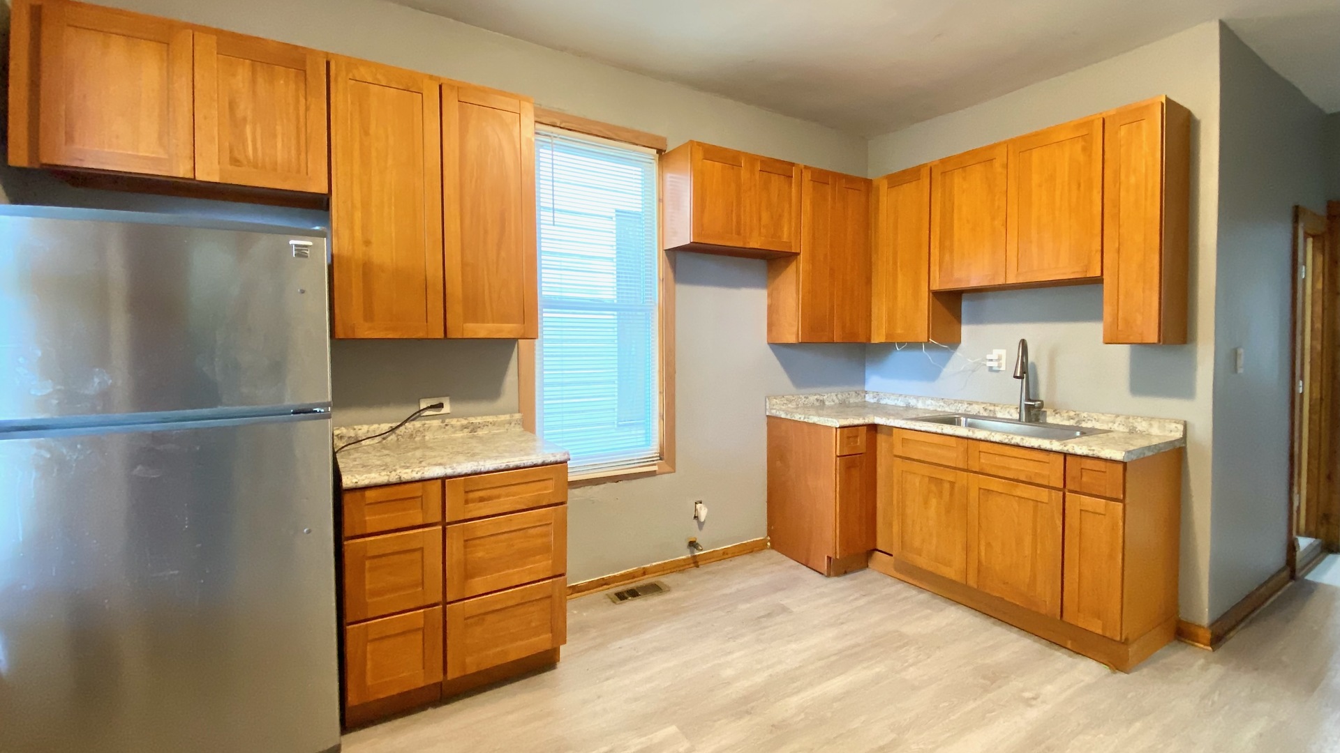 6833 South Green Street Chicago, IL 60621 - Photo 6 of 11 a kitchen with stainless steel appliances granite countertop a refrigerator sink and cabinets