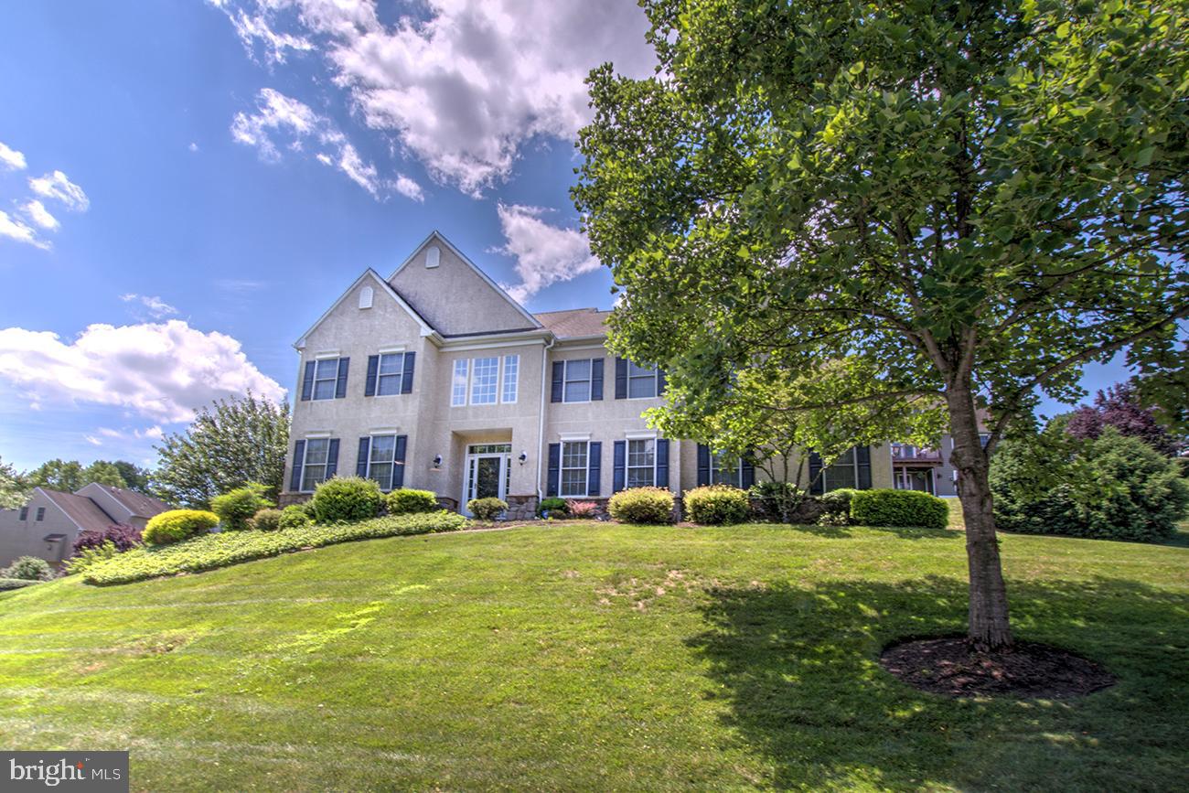 816 Shadebrush Ridge Road West Chester, PA 19382 - Photo 1 of 44 a front view of a house with garden and trees