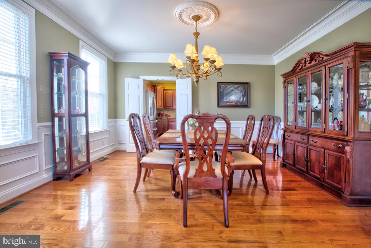 816 Shadebrush Ridge Road West Chester, PA 19382 - Photo 14 of 44 a view of a dining room with furniture a chandelier and wooden floor