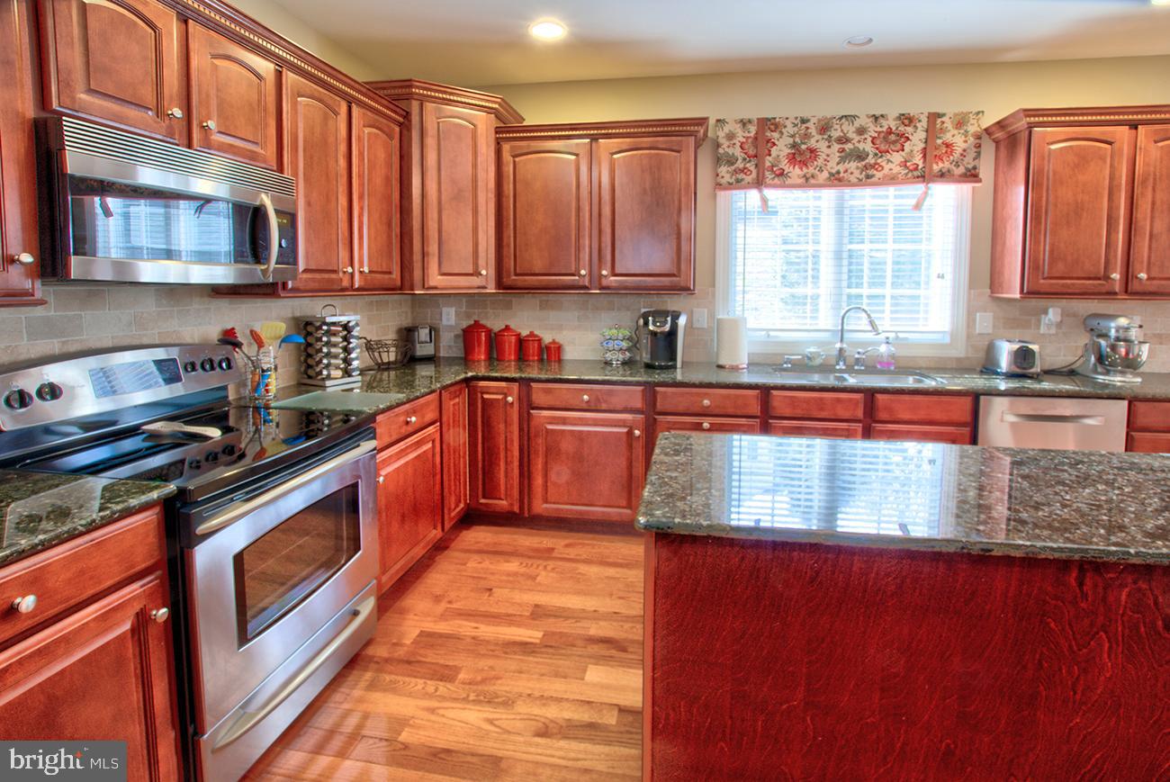 816 Shadebrush Ridge Road West Chester, PA 19382 - Photo 19 of 44 a kitchen with stainless steel appliances granite countertop a stove a sink and a microwave