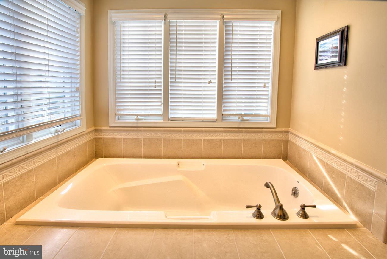 816 Shadebrush Ridge Road West Chester, PA 19382 - Photo 33 of 44 a bathroom with a bathtub and next to a window