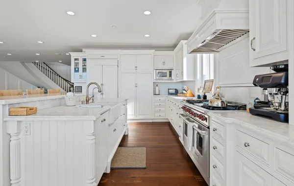 a kitchen with stainless steel appliances a sink stove and cabinets