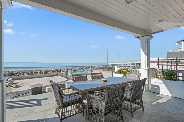 a view of a patio with a table and chairs