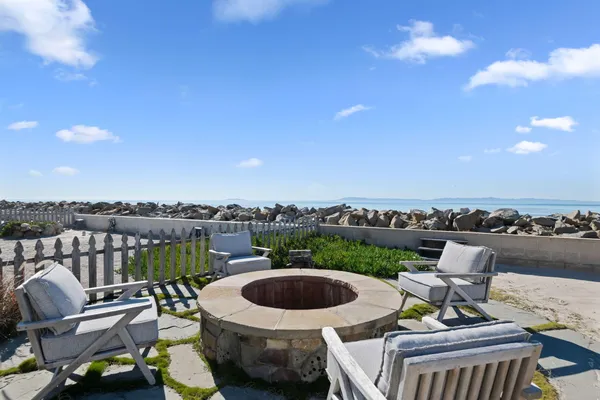 a view of a balcony with furniture and a garden