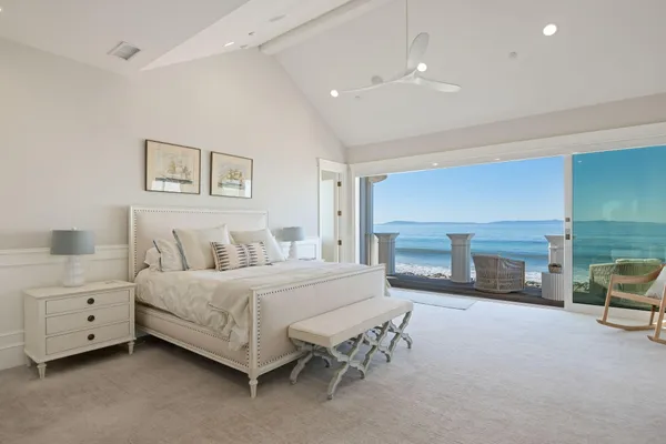 a spacious bedroom with a bed and a fireplace