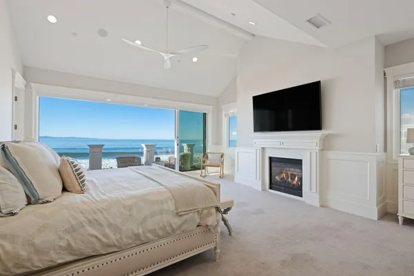 a spacious bedroom with a bed and a flat screen tv