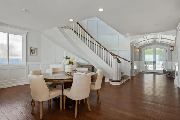 a view of a dining room with furniture a livingroom and wooden floor