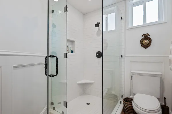 a bathroom with a shower a toilet and sink