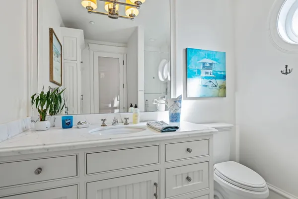 a bathroom with a sink a toilet and mirror